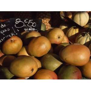  Mangoes and Melons Priced in Euros For Sale at a Market in 