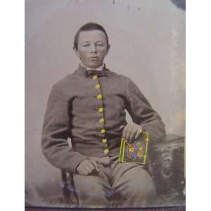   young soldier in Confederate uniform holding book