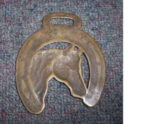 nice old antique horse brassof a horses head in a horseshoe. It 