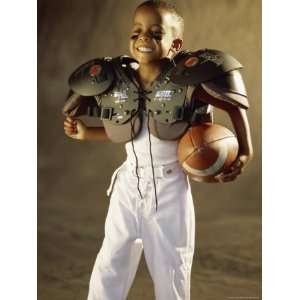  Boy in a Football Uniform Holding a Ball Premium 